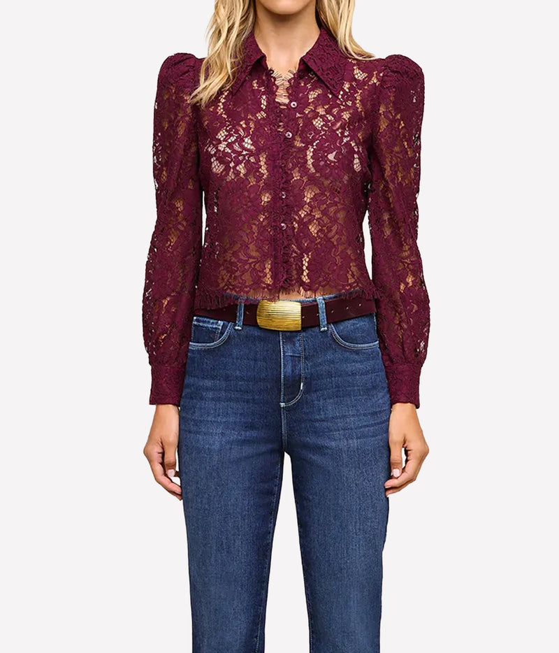 L'Agence Anita Lace Blouse In Deep Sangria - model wearing red lace blouse and blue denim jeans