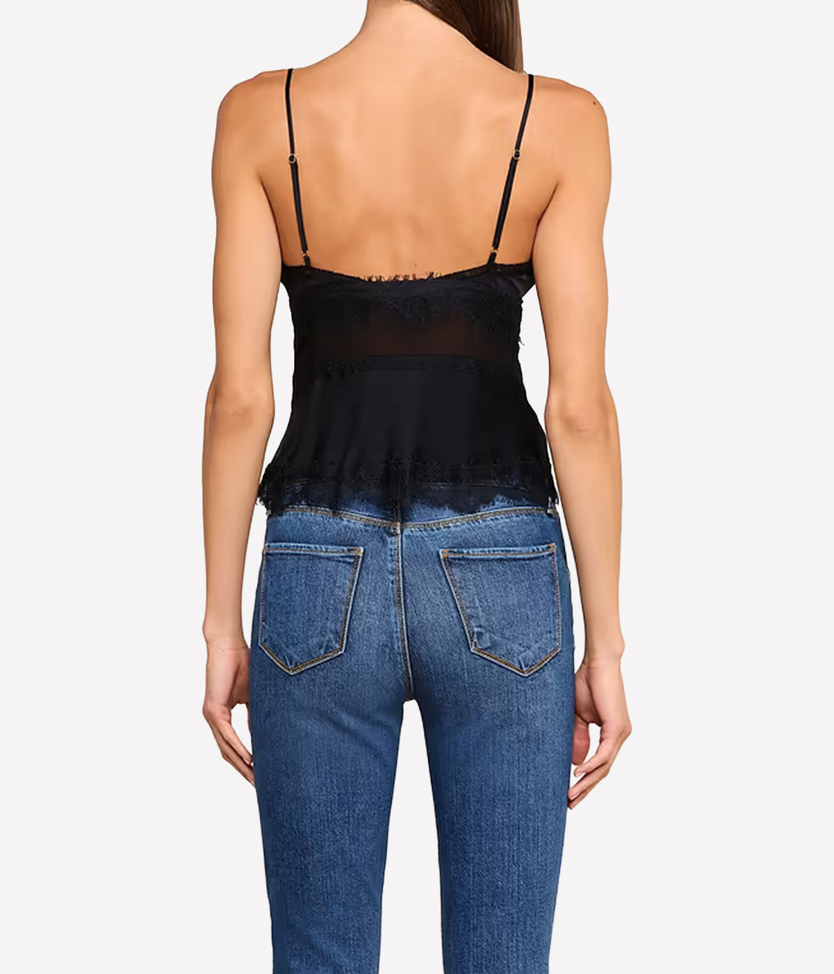 A woman shown from the back wearing the L'AGENCE Elka Satin Lace Camisole in Black and blue jeans.