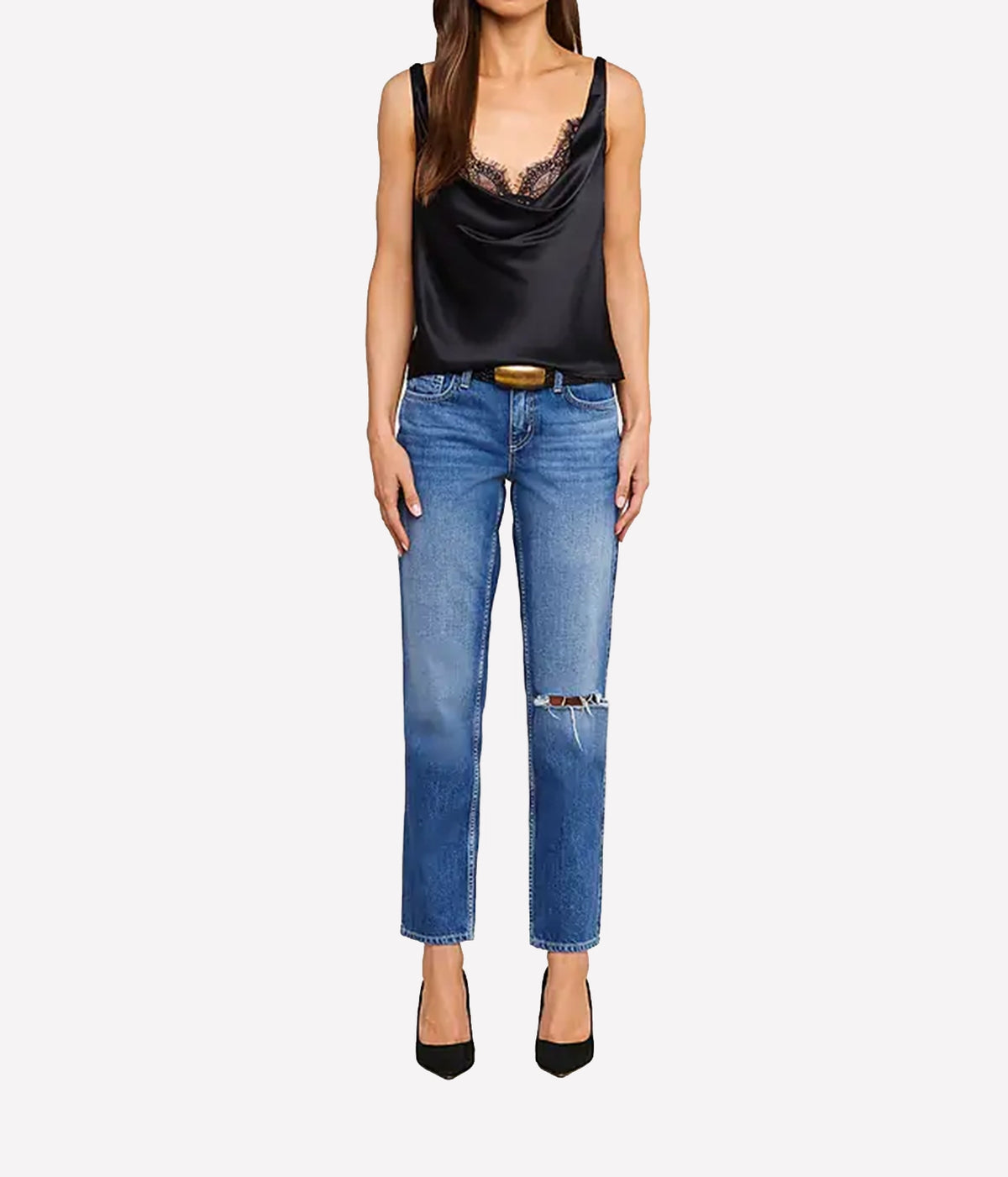 A model wearing the L'AGENCE Evadne Silk Lace Camisole in Black with lace trim, blue jeans, and black pointed-toe heels.