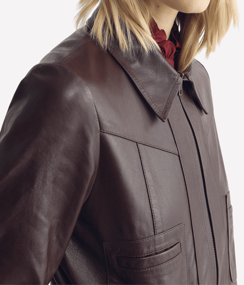 Close-up of the Nili Lotan Charly Leather Jacket in Bordeaux on a model, showing the pointed collar, front zip, Western yoke stitching and chest pocket
