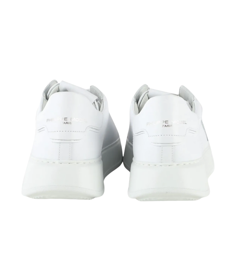 A pair of white leather sneakers shown from the back