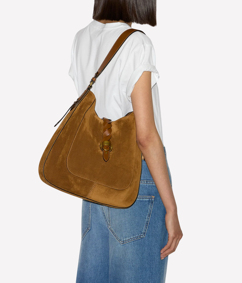 Model wearing the Isabel Marant Altay Hobo Day Bag in Cognac over the shoulder, showing the bag’s size and relaxed hobo shape.