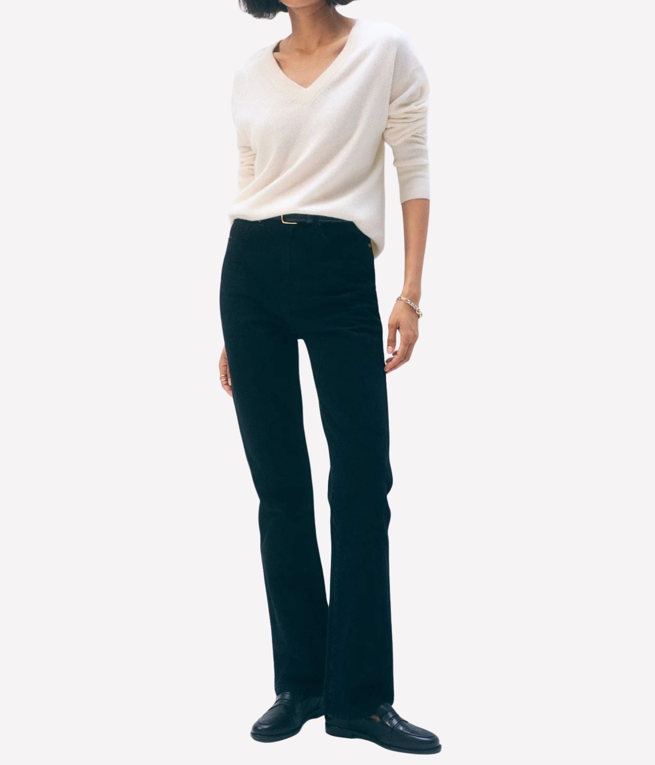 A model wearing a cream V-neck knit sweater