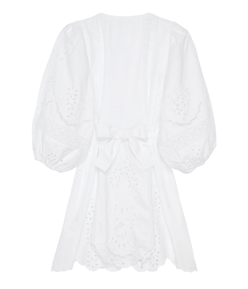 Back view of the Sissel Edelbo Mila Short Dress in Ecru, showing the balloon sleeves, side ties and wavy cutwork hem