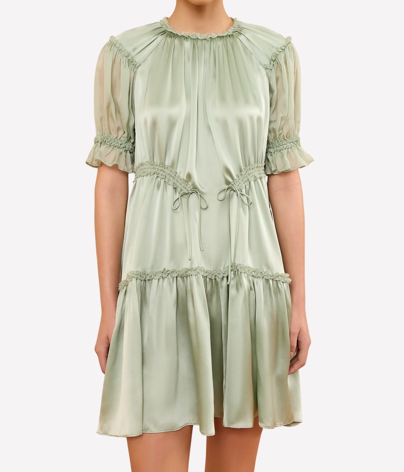 Model wearing the Juliette Short Sleeve Mini Dress in Cleadon, shown from the front with its gathered neckline, short puff sleeves and tiered mini skirt.