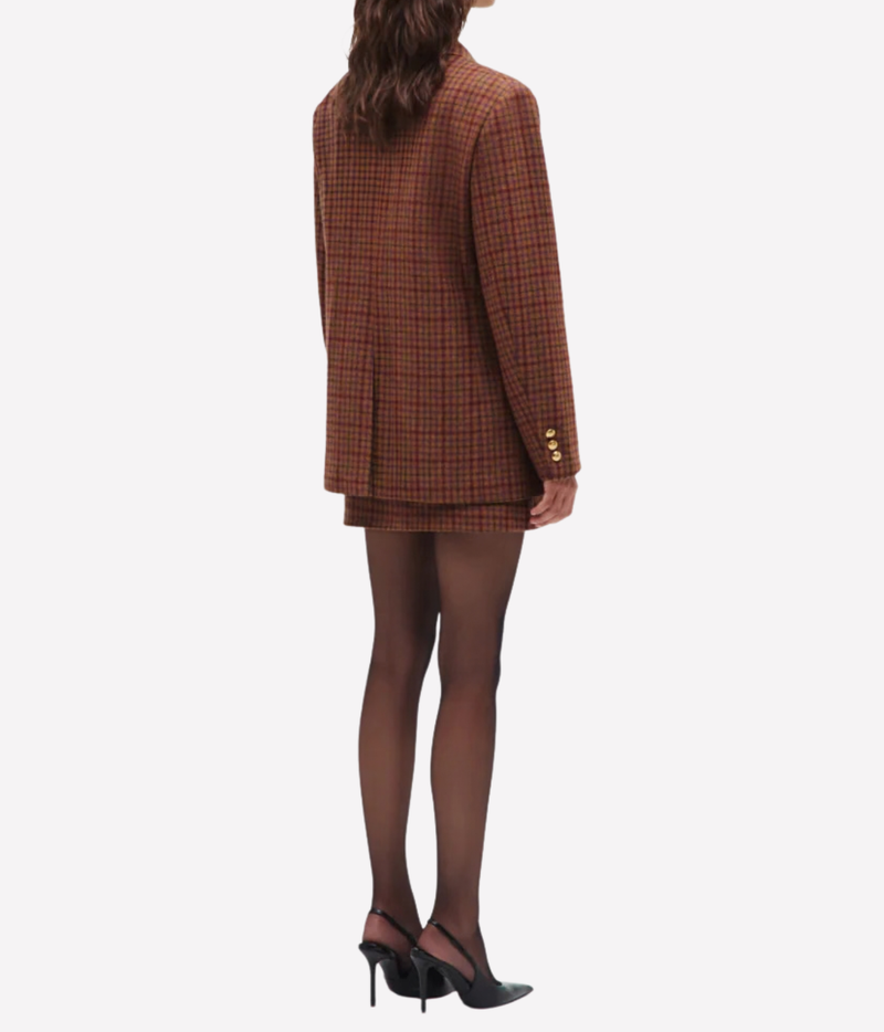 A model shown from the back wearing the Blazé Milano Sweet Sea Nightbreak Blazer in Cinnamon Mix with gold buttons, paired with sheer black tights and black slingback heels