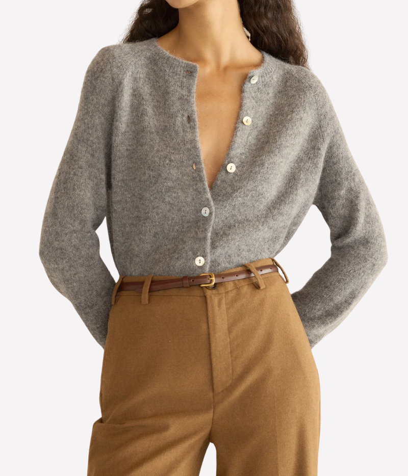 A woman wearing a grey knit cardigan with front buttons front view
