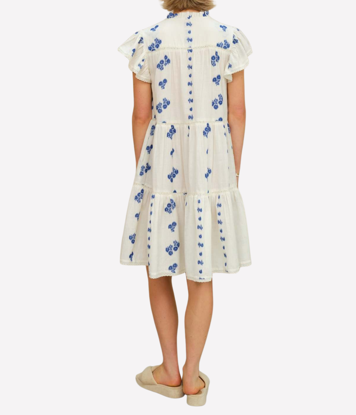 Model wearing the M.A.B.E Iris Woven Frill Short Dress in Blue – back view