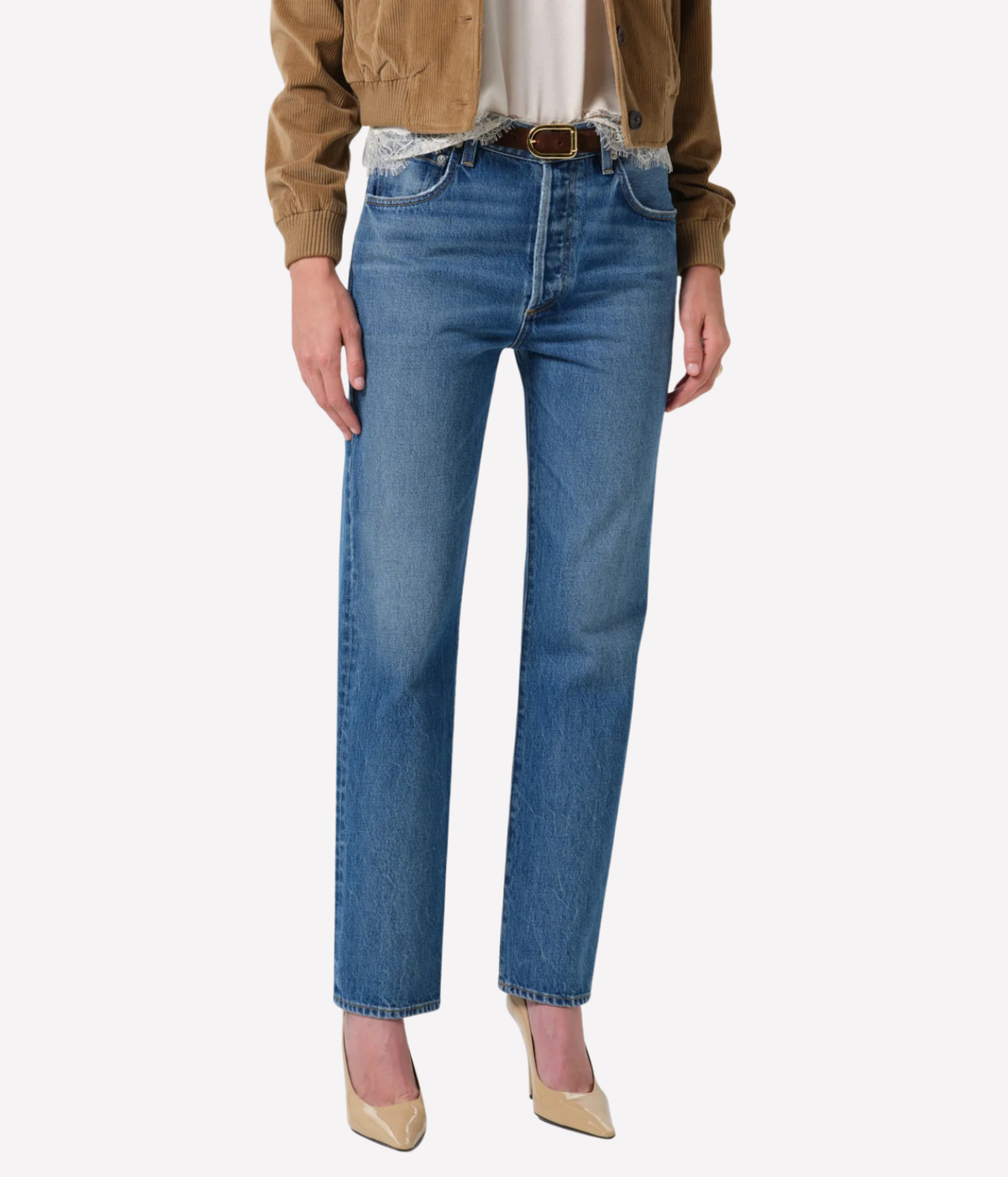 Model wearing the Citizens of Humanity 90s French Straight in Pastis with a brown leather belt, a cream lace-trim top, a tan cropped jacket and nude pointed heels, showing the straight leg and ankle length