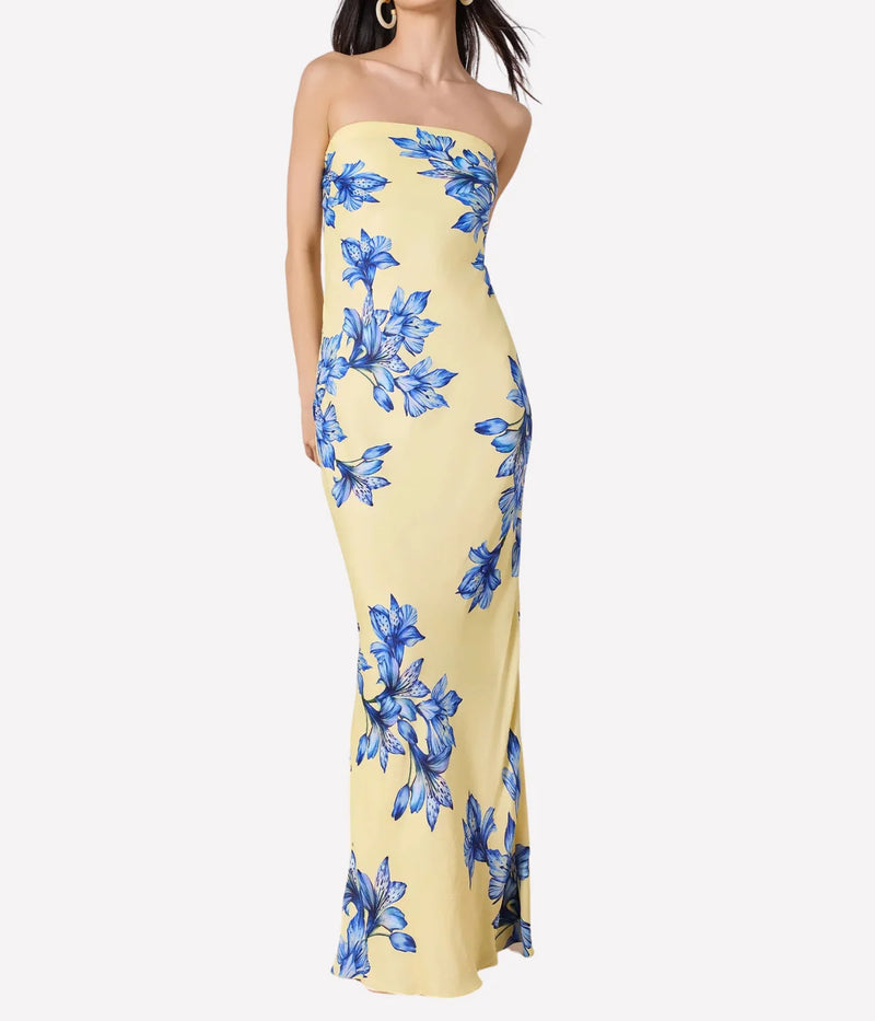 Yellow strapless dress with blue floral pattern on a white background