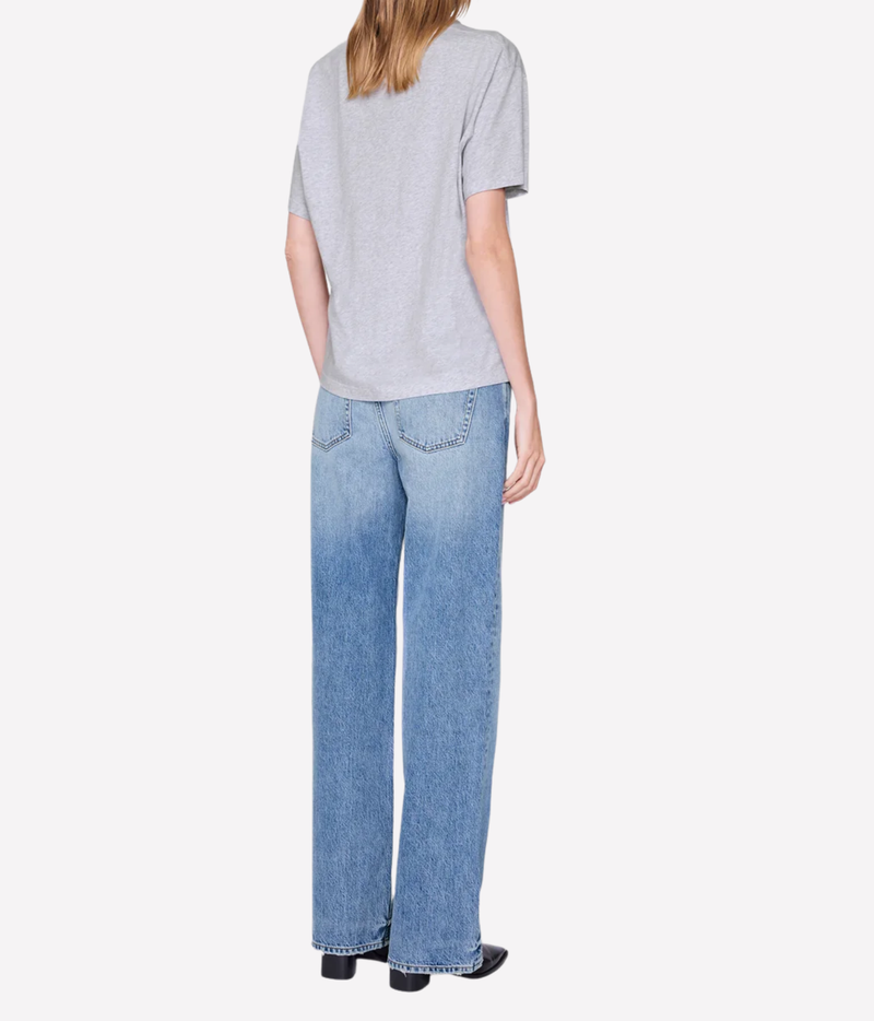 A model shown from the back wearing a light gray short-sleeve t-shirt and light blue wide-leg jeans, set against a plain light gray background.