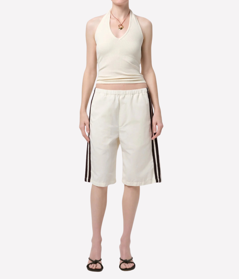 Citizens of Humanity Thea Halter in Dune, full-length styling with white knee-length shorts.