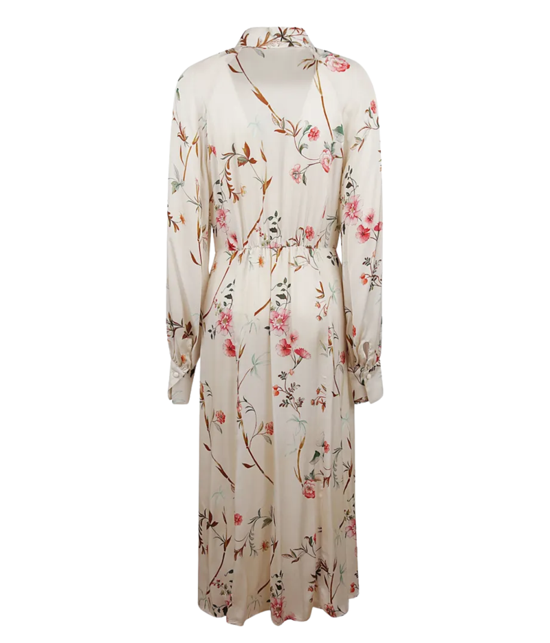 A long-sleeve midi dress with a wrap-style V-neck and waist tie, featuring an all-over floral and botanical print in pink, green, and brown on a cream background.