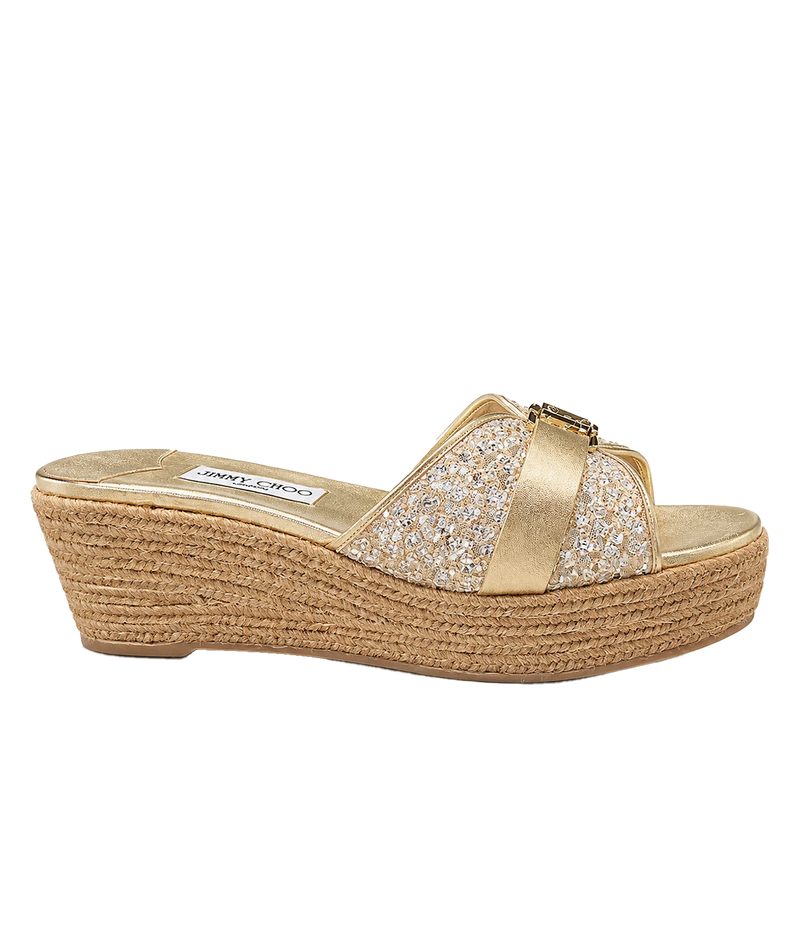 A single Jimmy Chono espadrille wedge sandal in metallic gold, featuring crystal-embellished straps and a braided jute wedge heel, shown from a side profile on a white background.
