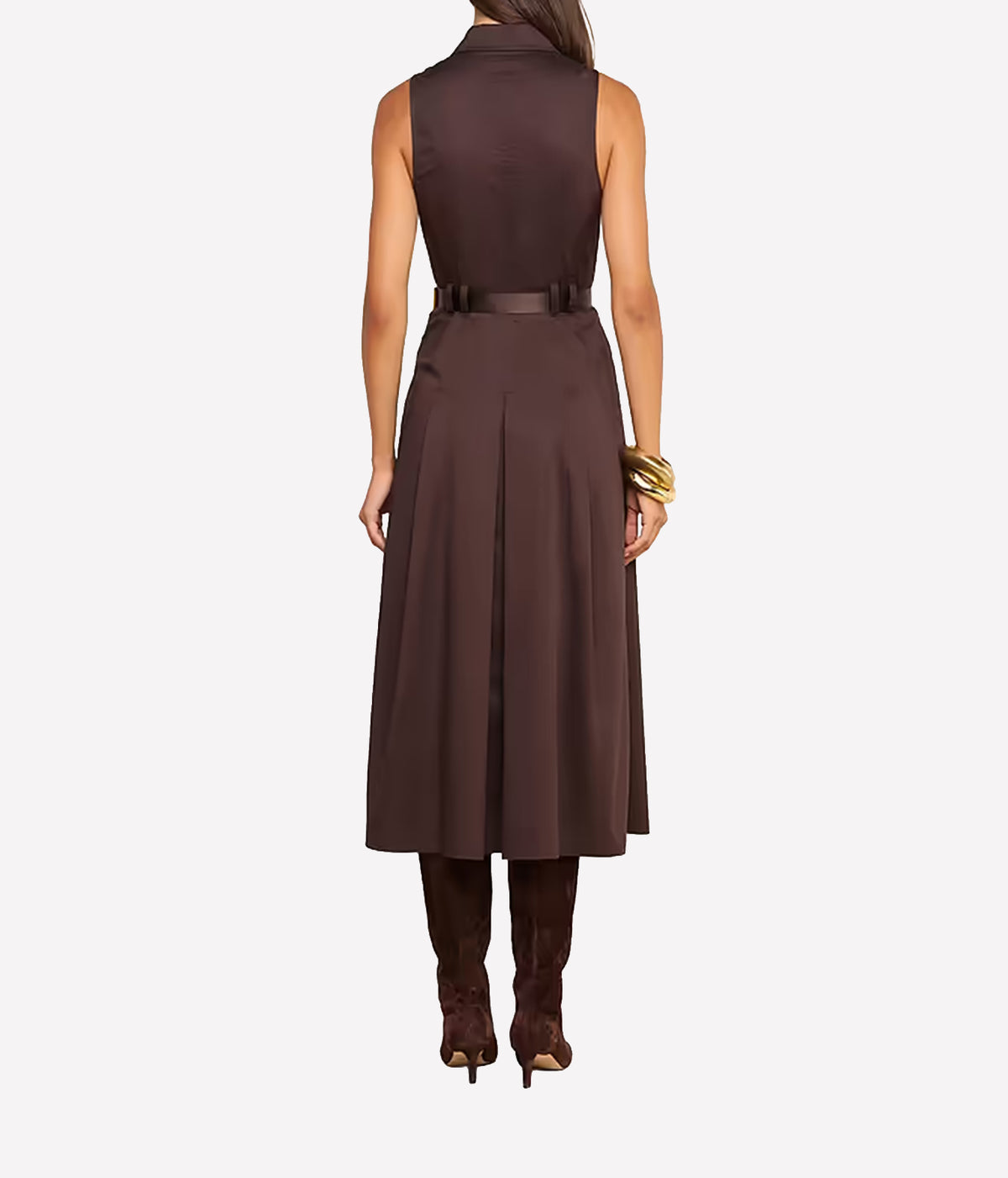 A woman shown from the back wearing a sleeveless dark brown midi dress with a matching belt, brown boots, and a gold bracelet.