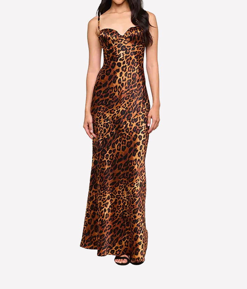 A woman modeling a leopard-print maxi dress with a sweetheart neckline and thin shoulder straps.