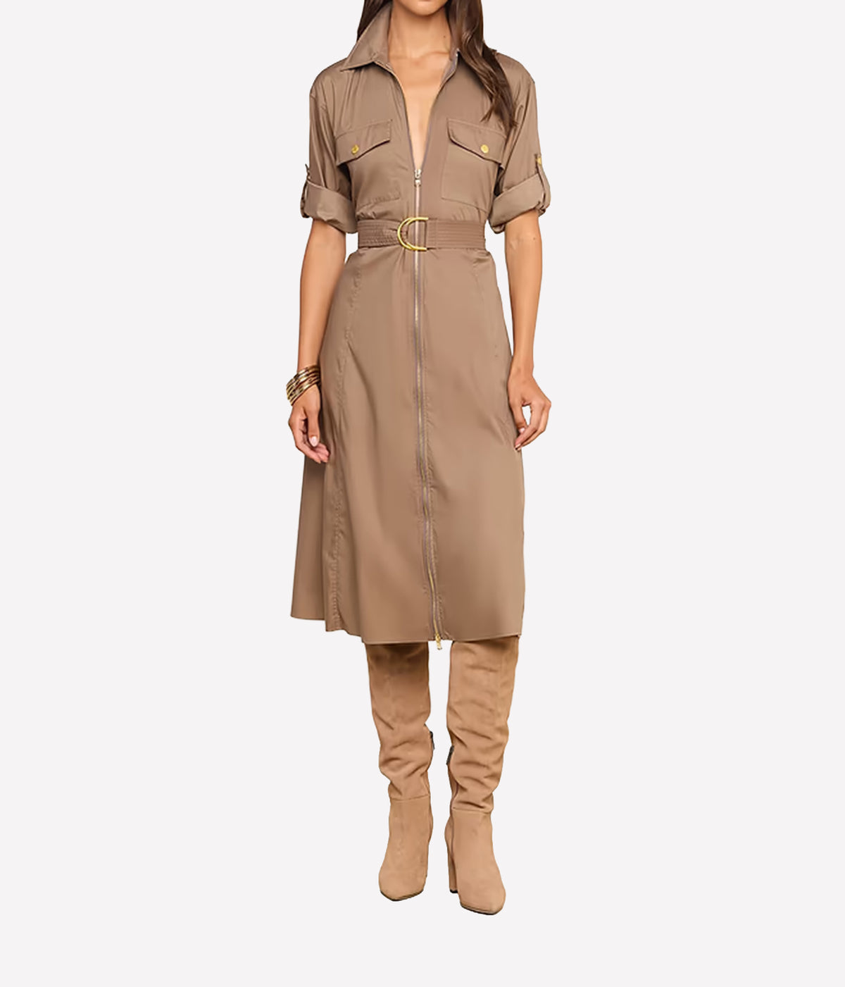 A model wearing a taupe-brown short-sleeve shirt dress with a front zipper, belt, and gold-tone hardware, paired with matching taupe over-the-knee boots, against a light gray background.