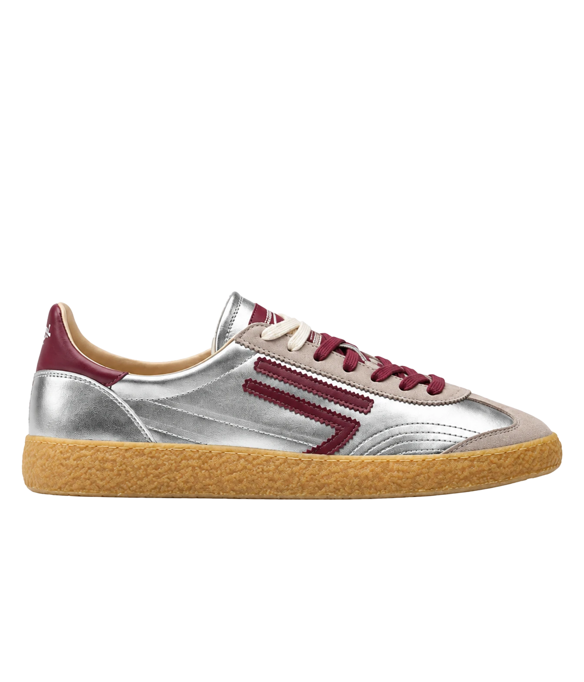 A low-top sneaker with a metallic silver leather upper, burgundy accents on the side stripes, heel tab, and laces, a beige suede toe cap, and a textured tan gum sole, shown in a side profile on a white background.
