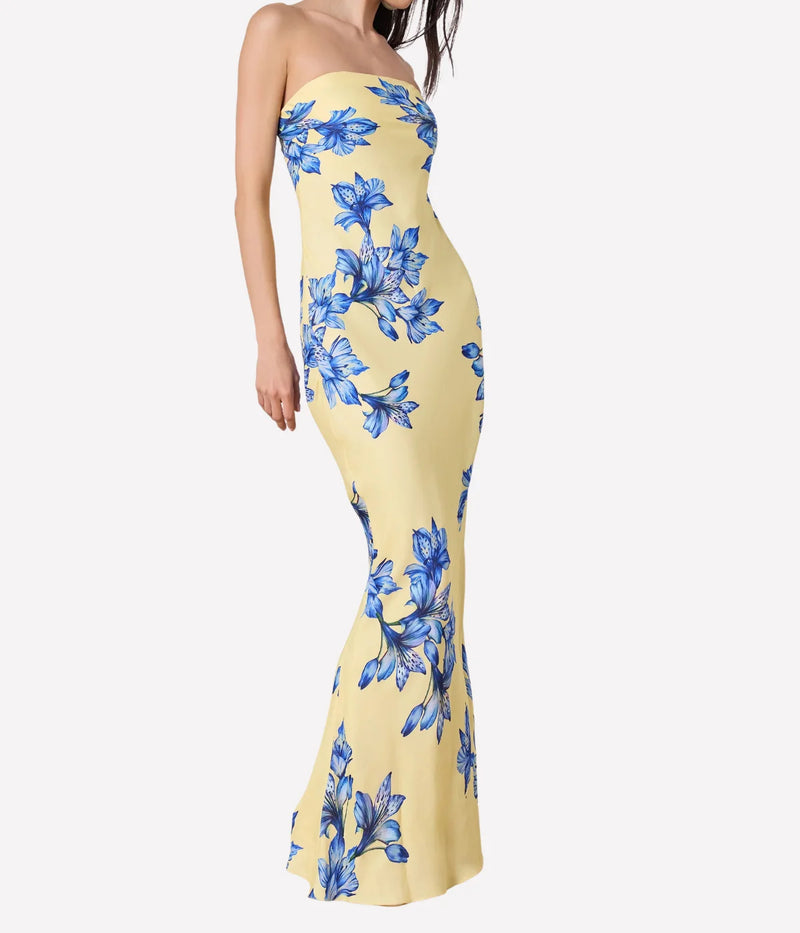 Yellow strapless dress with blue floral pattern on a white background