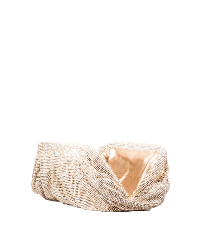 A gold rhinestone-embellished clutch purse with a satin lining, photographed on a solid white background.