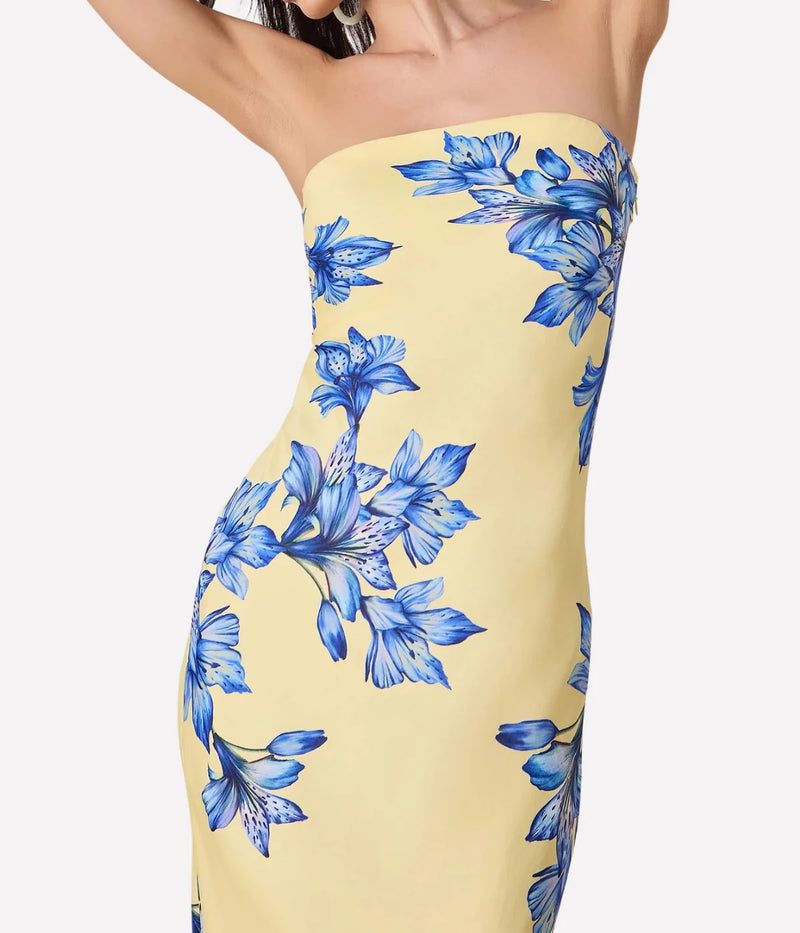 Yellow strapless dress with blue floral pattern on a white background
