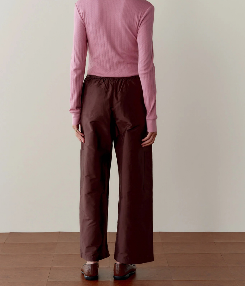 DONNI. Silk Taffeta Cargo Pant in Espresso styled on model, back view showing crop length