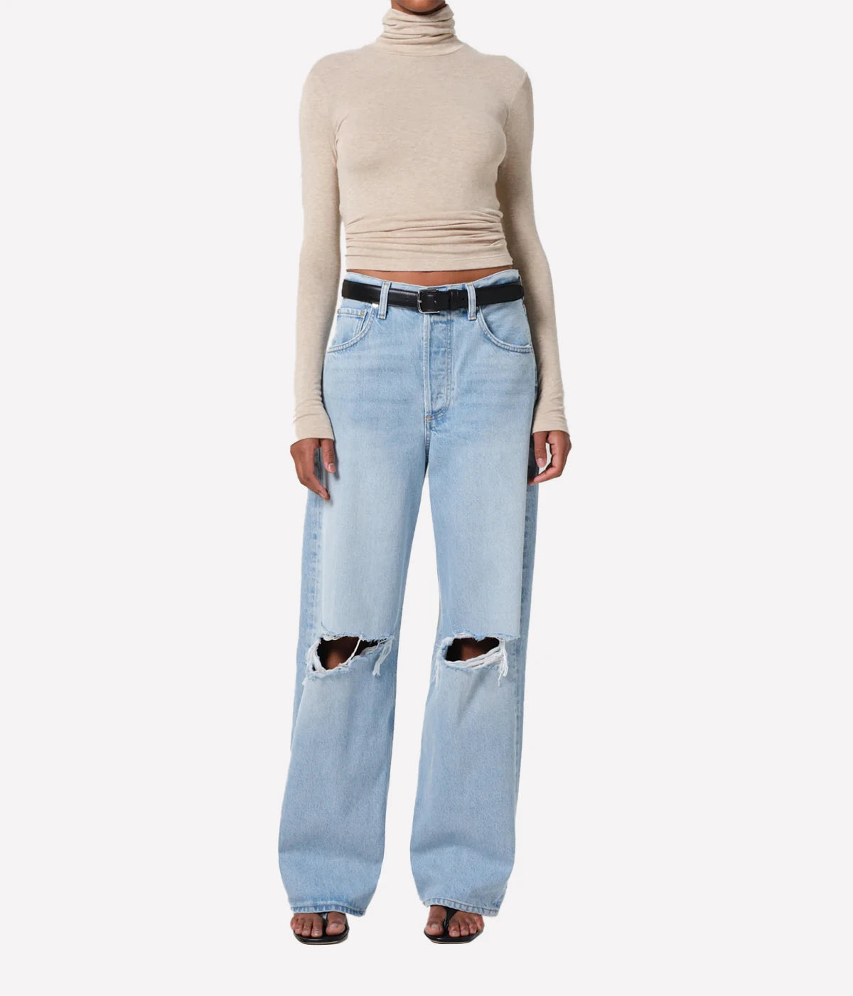 ALT Text: Caradene Turtleneck in Heathered Almond, featuring a soft, light brown hue and a classic turtleneck design, displayed on a hanger.