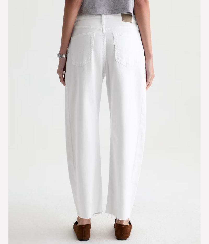 White wide-leg cropped jeans shown from the back on a model, paired with a gray top and brown flat shoes against a light gray studio background.