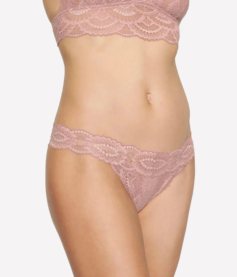 Model wearing the Eberjey Mariana Thong in Woodrose, front view showing the scalloped lace waistband, worn with the matching lace bralette