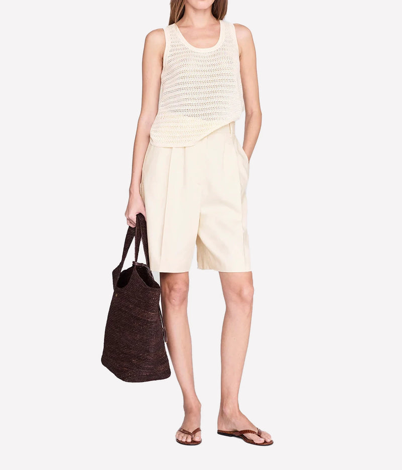 arie tank in ivory by anine bing - full body model shot with cream trouser shorts and brown woven bag
