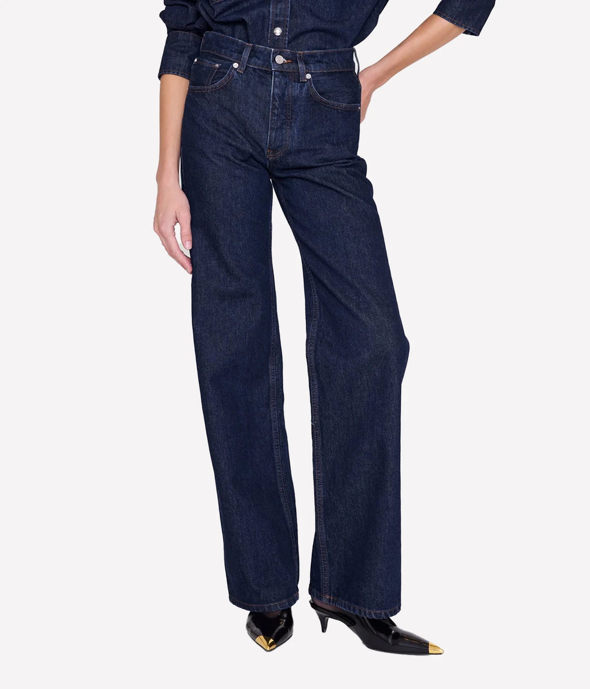 Model wearing the Anine Bing Hugh Jean in Unwashed Blue, showing the high-rise waist and relaxed wide-leg fit.
