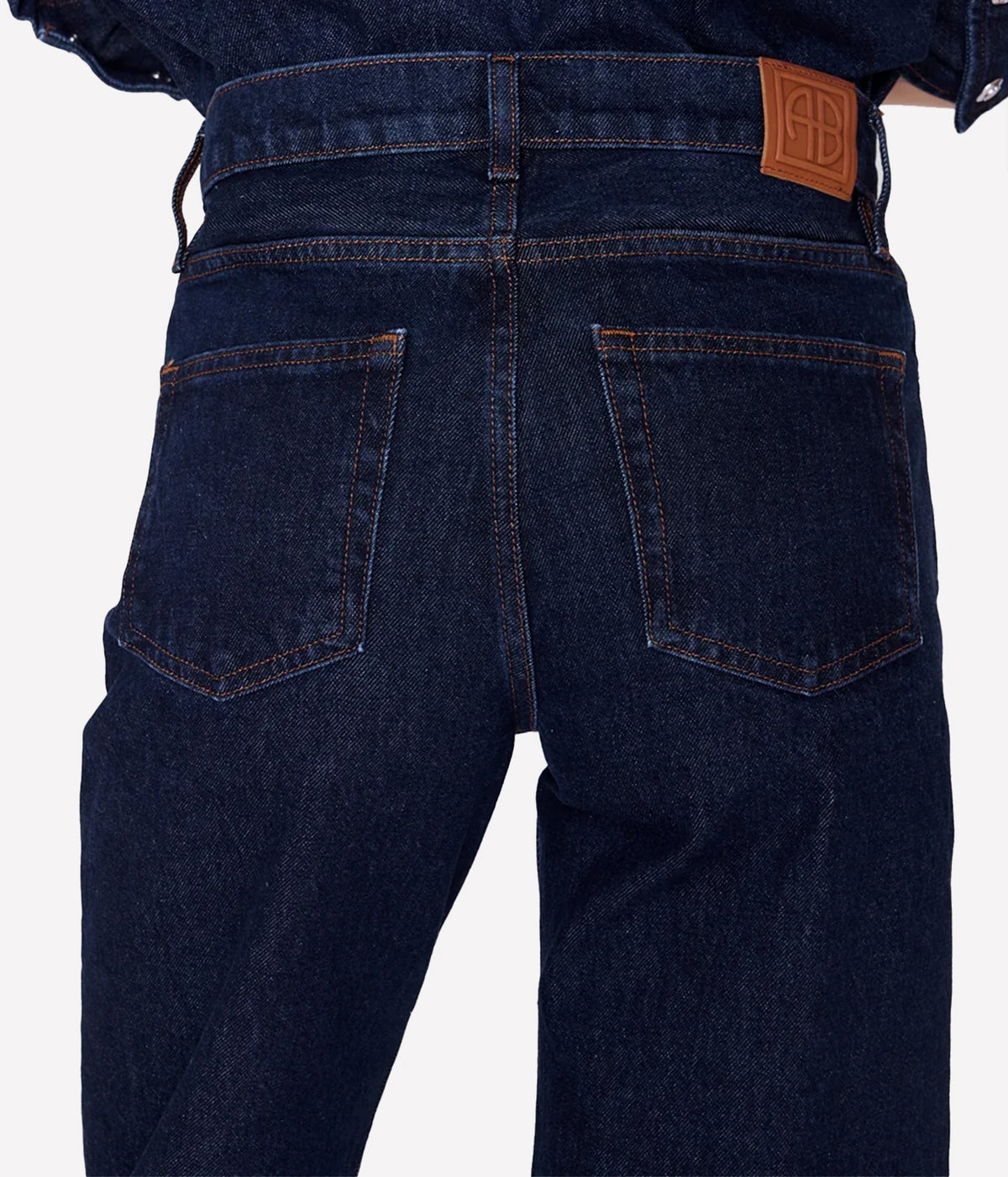 Close-up back view of the Anine Bing Hugh Jean in Unwashed Blue showing rear pockets, waistband and logo patch.