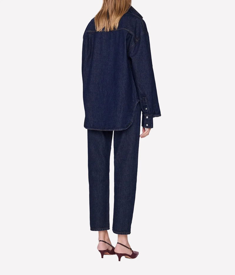 Model wearing the Anine Bing Samy Shirt in Unwashed Blue with matching jeans, shown from the back.