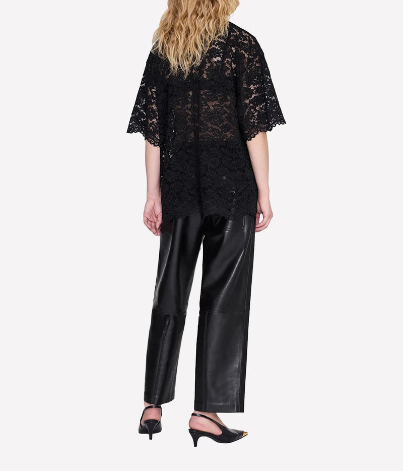 Model wearing the Anine Bing Zeina Top in Black Lace with black trousers, shown from the back to highlight the relaxed fit and lace detailing.