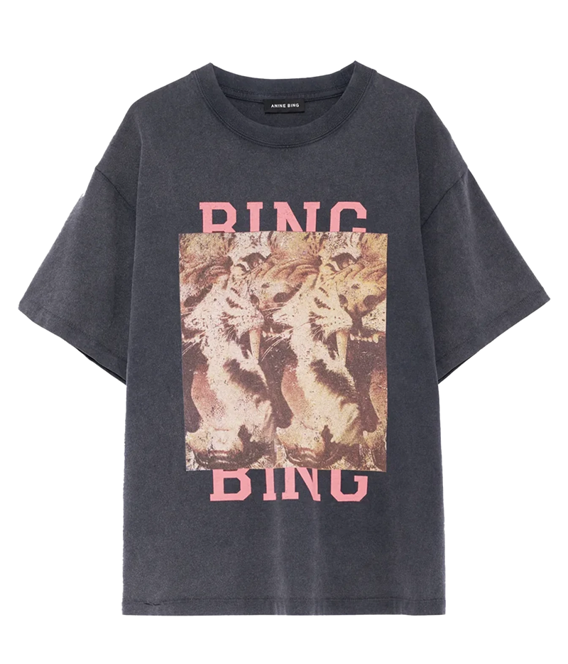 A dark gray washed graphic t-shirt featuring a square print of three lions in the center with the word 'RING' in pink above and below, displayed on a clean white background.