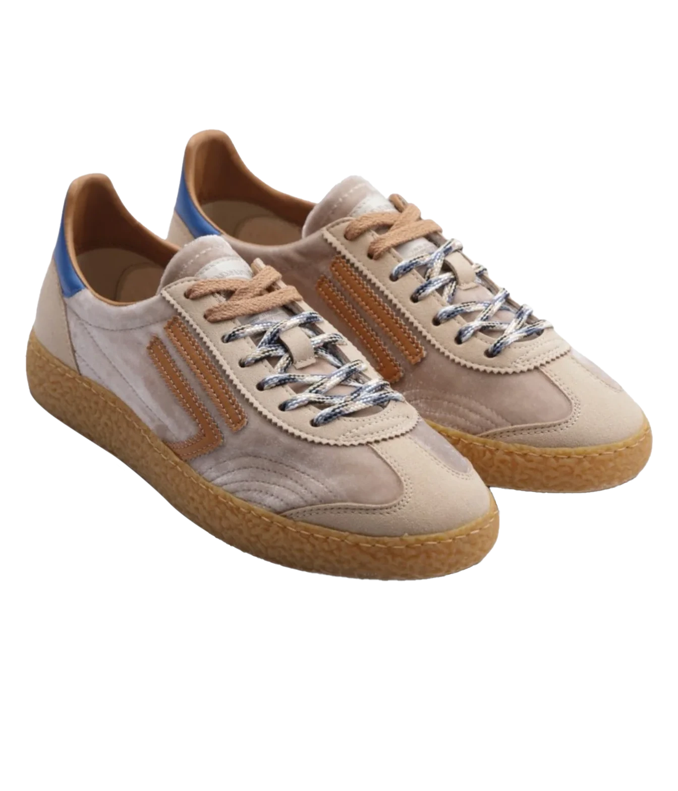 A pair of low-top suede sneakers in beige and light brown, featuring textured gum soles, metallic silver laces, and a small blue accent on the heel.