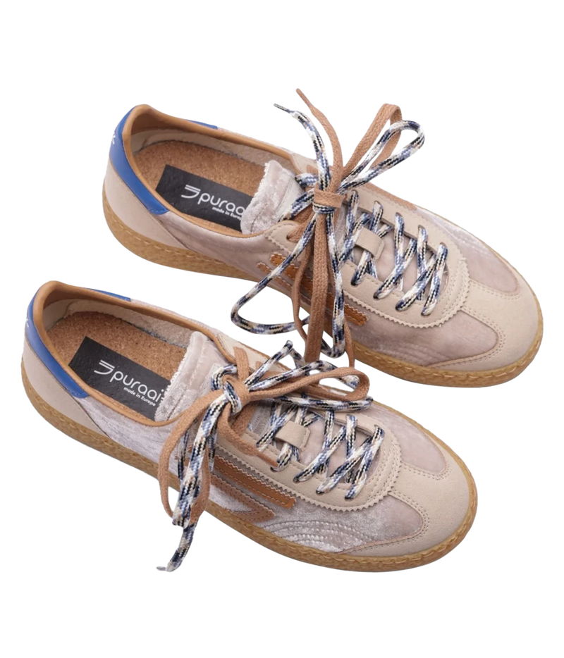 A pair of Puradoi low-top sneakers in beige suede and mesh, featuring brown laces with silver reflective threads, a blue heel accent, and a brown jute sole, shown on a white background.