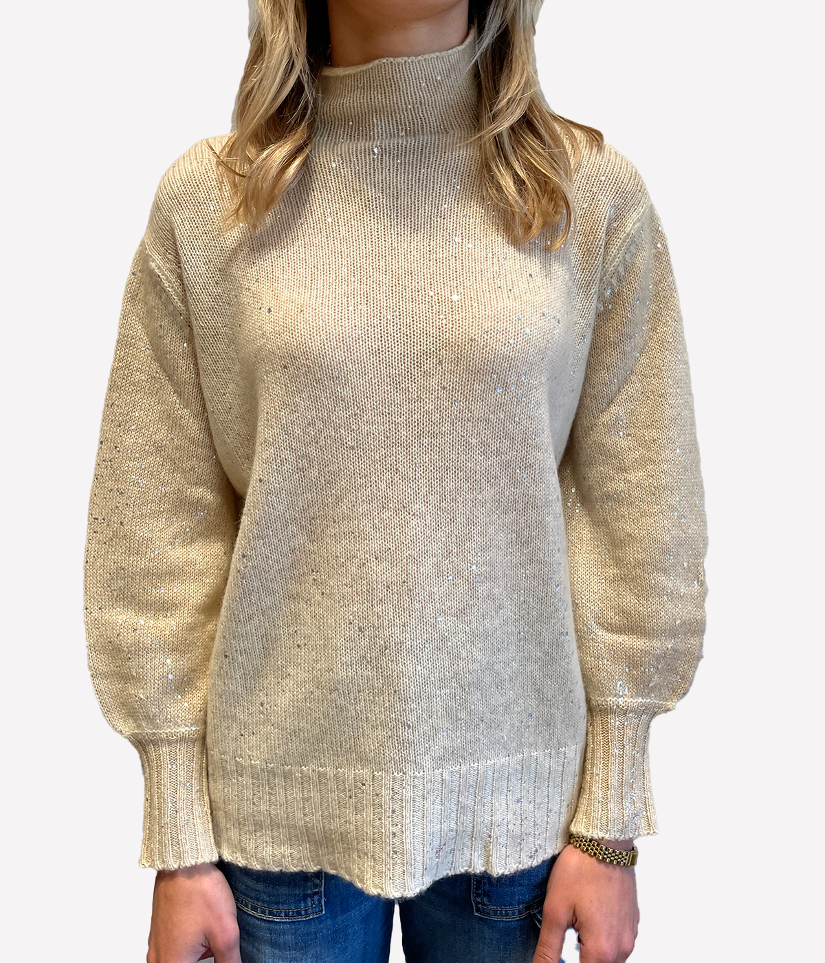 ALT text: Model wears Burro coloured oversized pullover with off-gauge knit, laminated finish, and voluminous sleeves