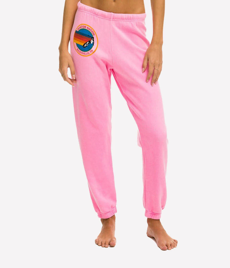  Ultra-soft sweatpants with unique stitching detail, shown in a casual lounge setting.