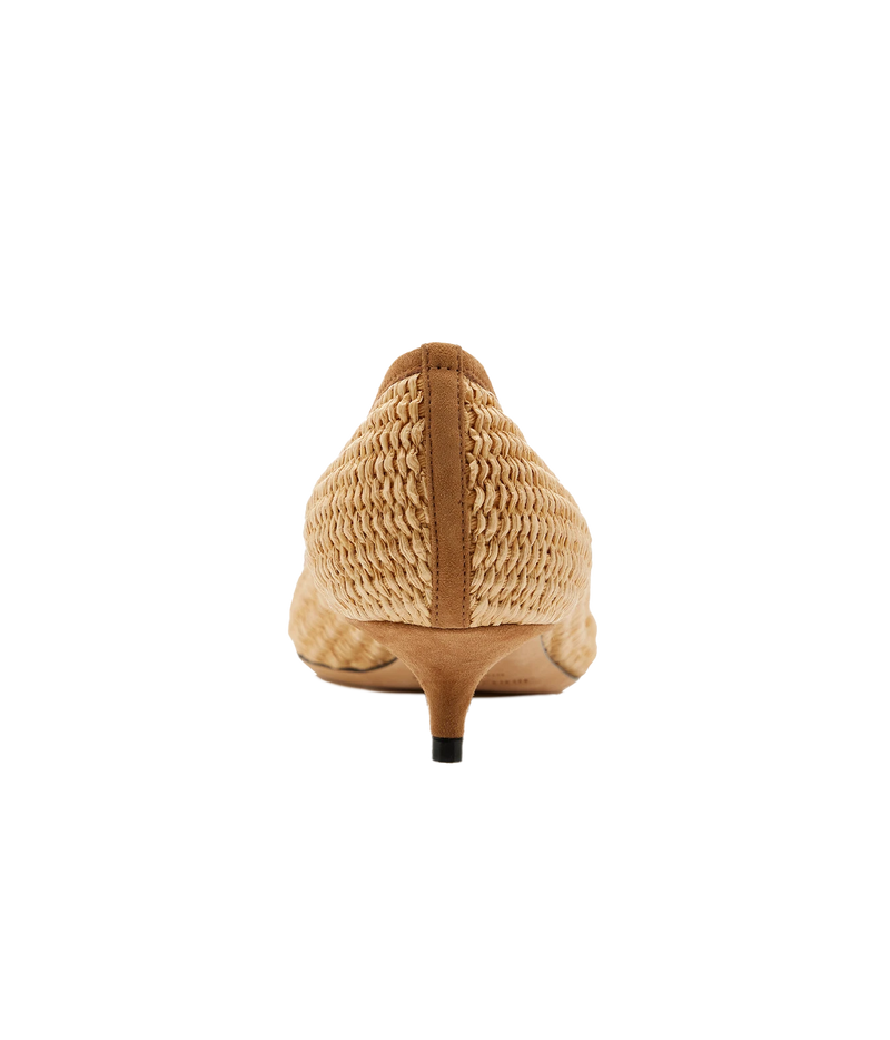 A single women's pointed-toe kitten heel shoe shown from the back, featuring a woven straw upper in a light tan color with smooth tan leather trim and a slim black-foiled heel.