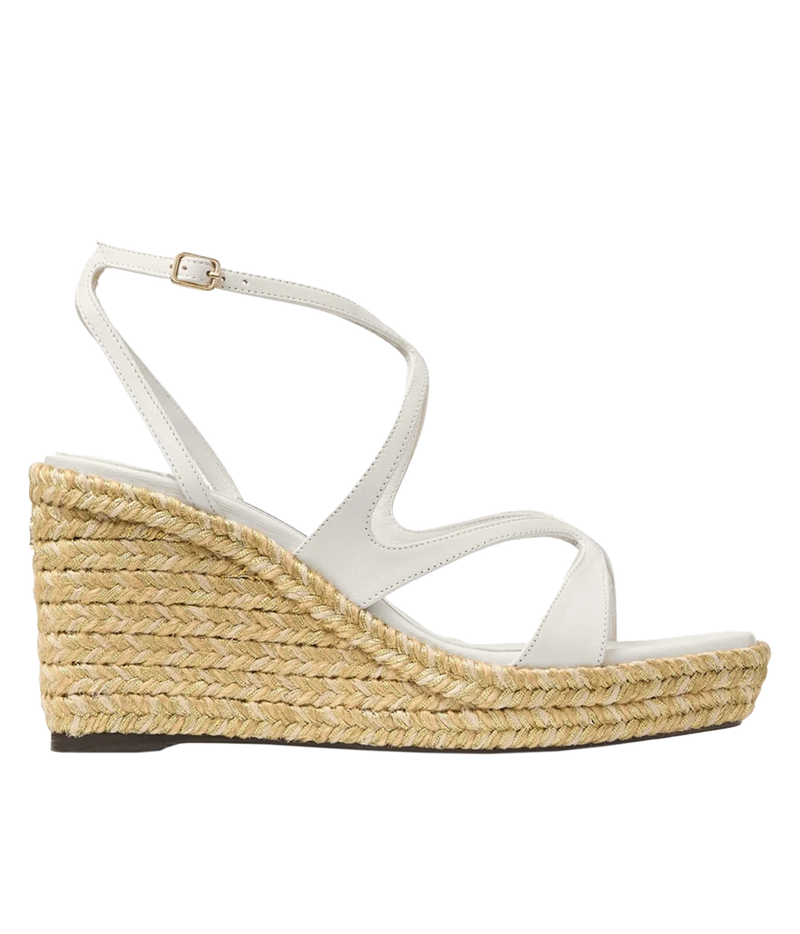 A single white leather wedge sandal with an ankle strap and a thick braided jute platform wedge heel, shown in a side profile on a white background.