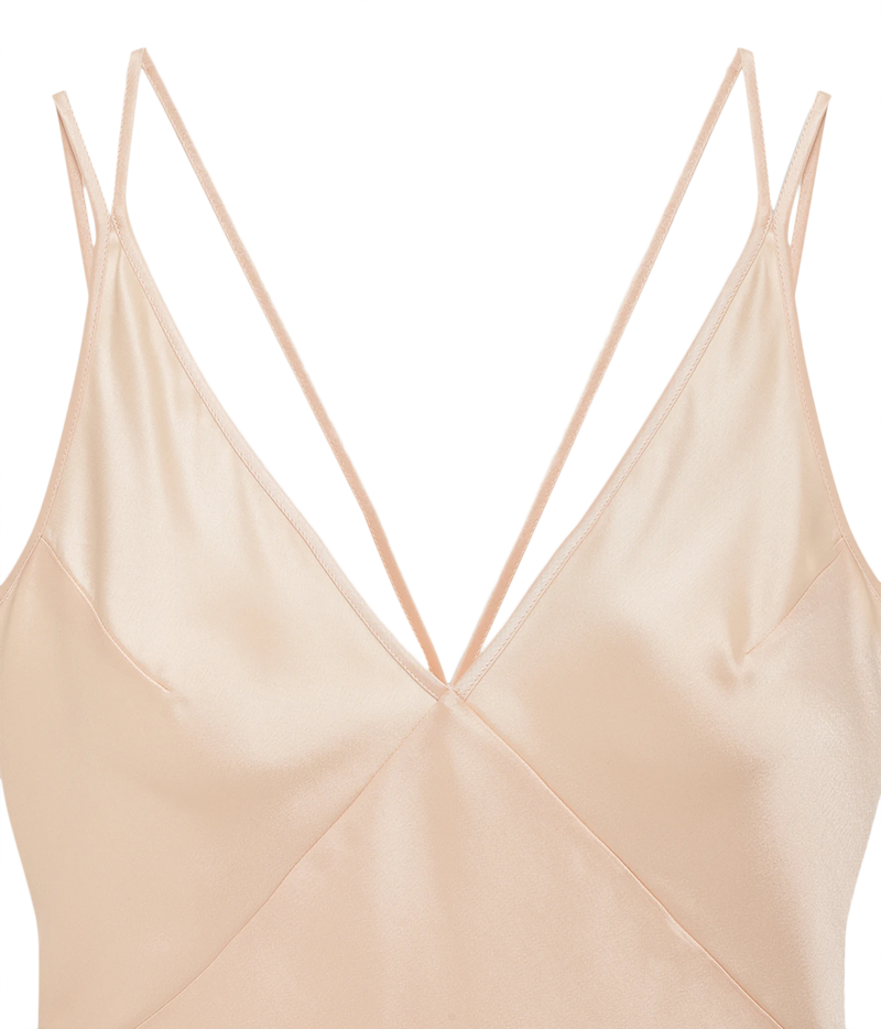 Close-up of a light beige satin camisole top with thin double spaghetti straps and a V-neckline, shown against a plain white background.