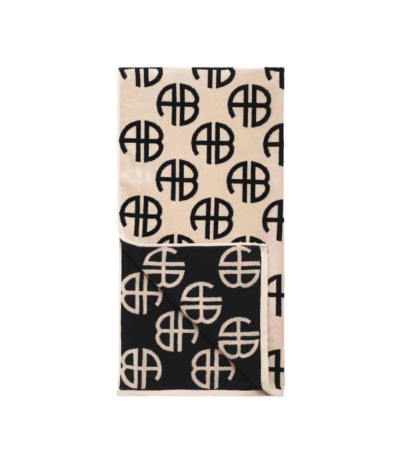 ALT text: ANINE BING Terry Towel in Beige featuring a large-scale monogram print on luxuriously soft terry-cloth fabric.