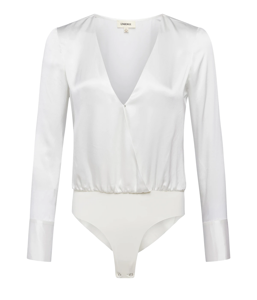 A sexy white plunge neck bodysuit made from luxurious silk material, featuring long sleeves, extended cuffs, button up detailing, and laser cut body suit pantie. Elevated basic, line free look, snap closure, date night top, bra friendly, throw on and go, comfortable, made internationally.   