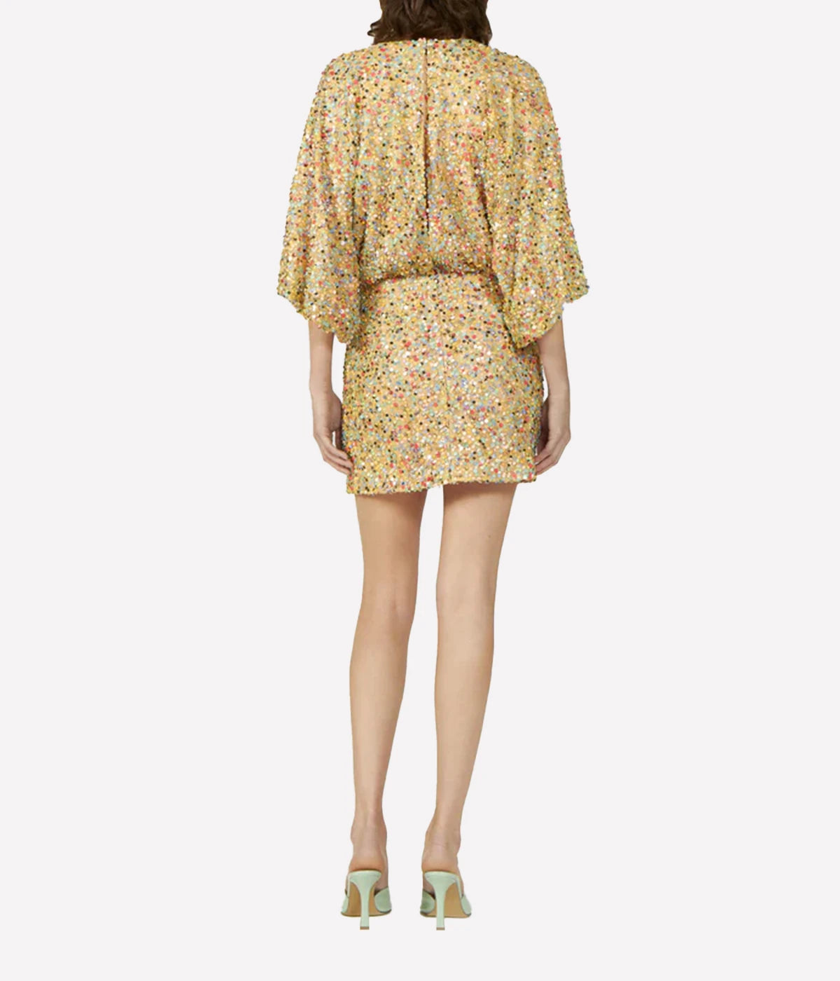 Beige multi-tone sequin mini dress styled with strappy heels for a glamorous evening look.