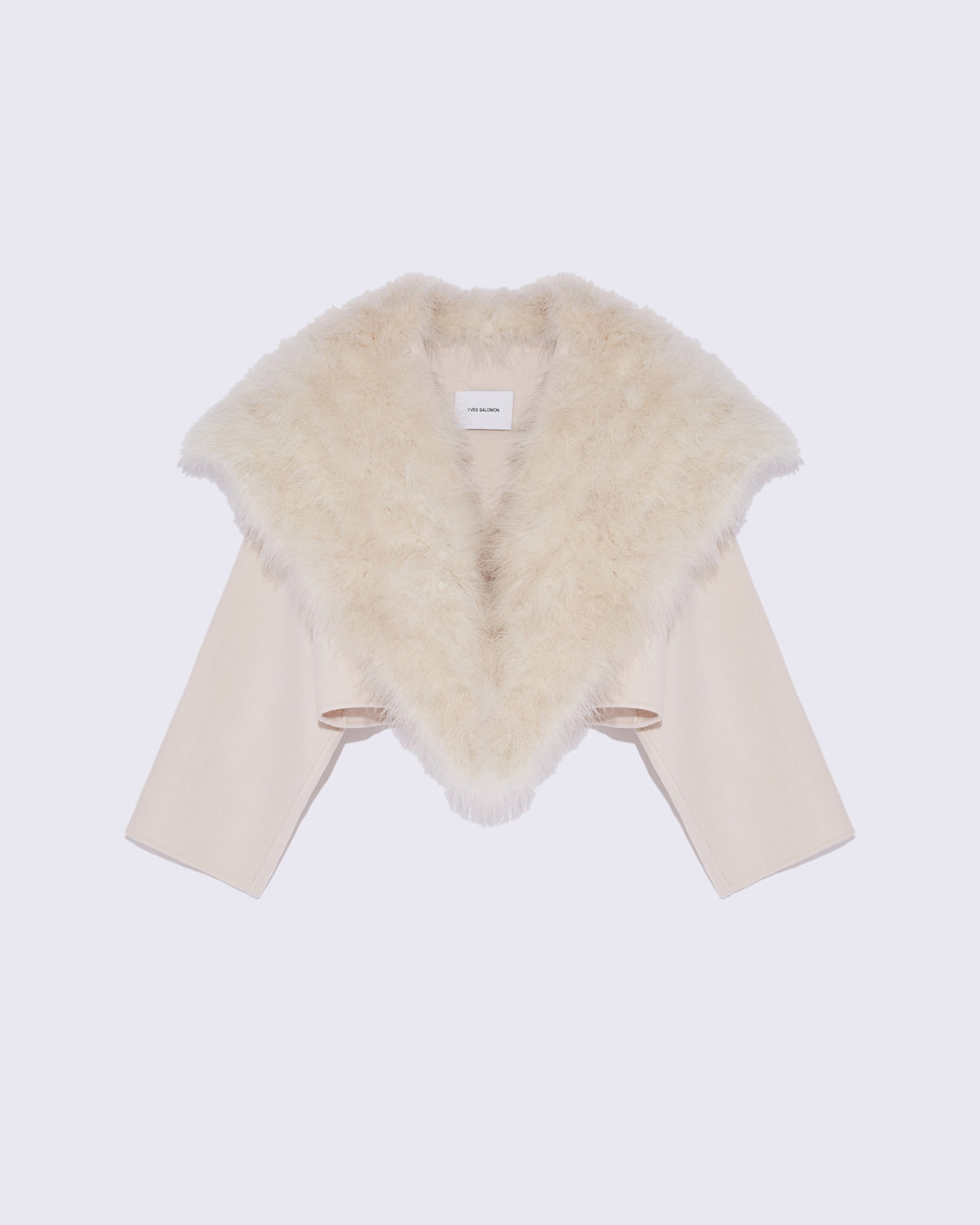 Luxurious cashmere V-neck sweater in leaf heather, styled with jeans and boots for a cosy yet refined look.