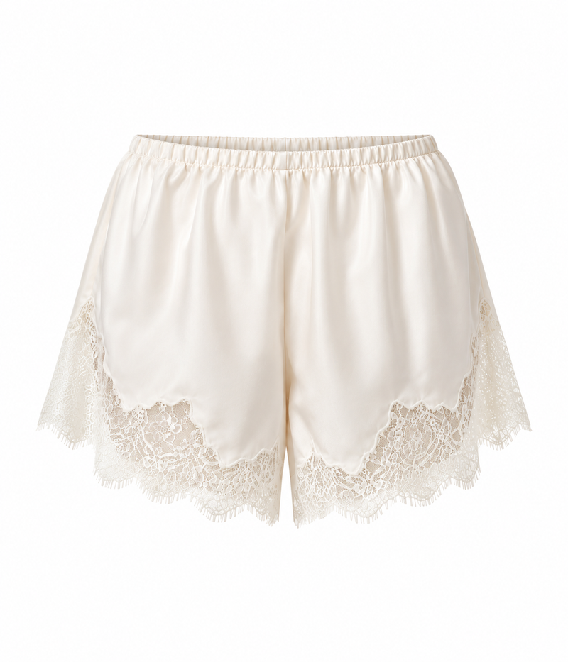 Product flat lay of a pair of cream lace-trimmed shorts - Lace Trimmed Tap Short in cream by Citizens of Humanity
