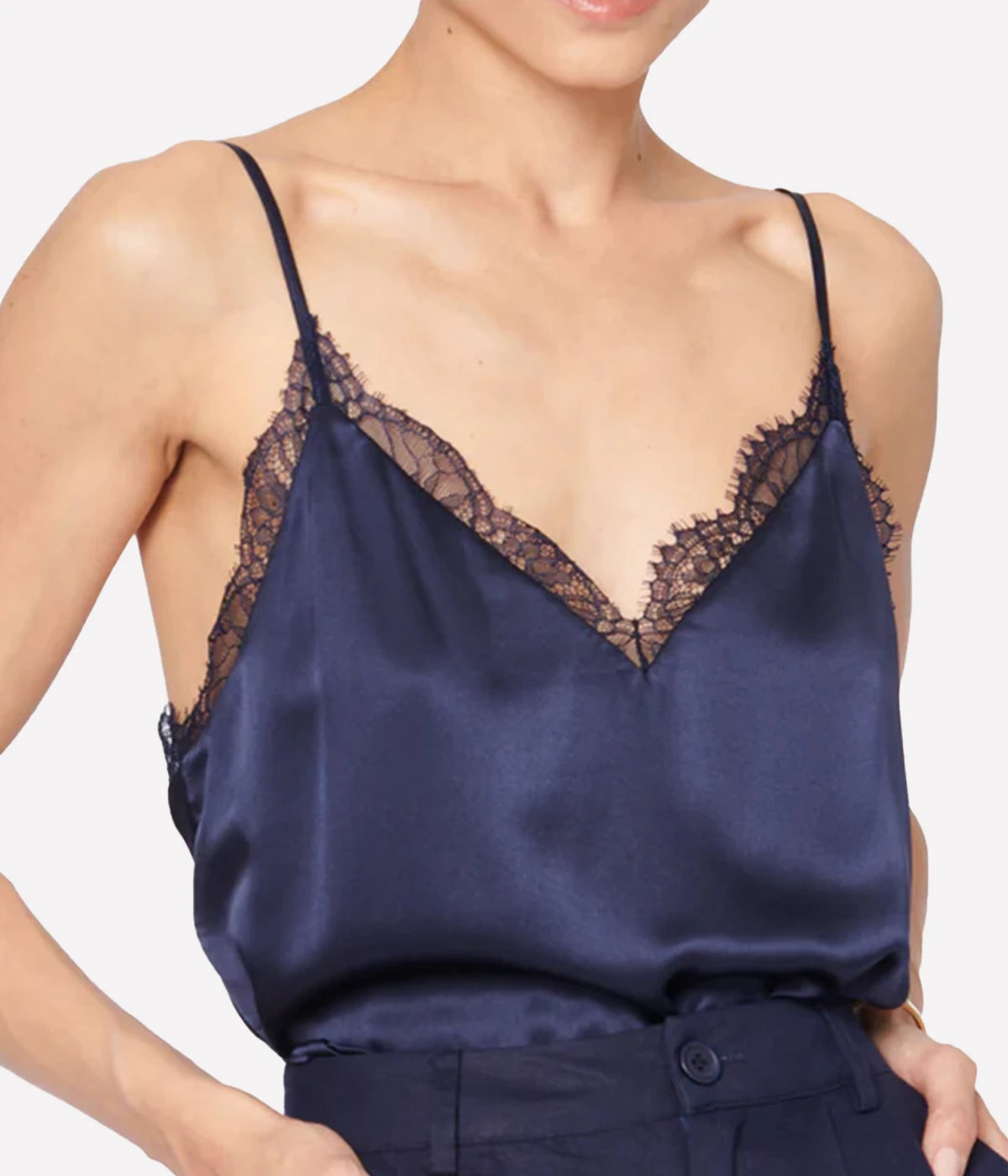 Image of a spaghetti strap navy silk camisole, with lace neckline detailing, low back neckline with a lace cross-over. Made internationally, trendy, sophisticated, fashion forward, date night top, sexy top. 