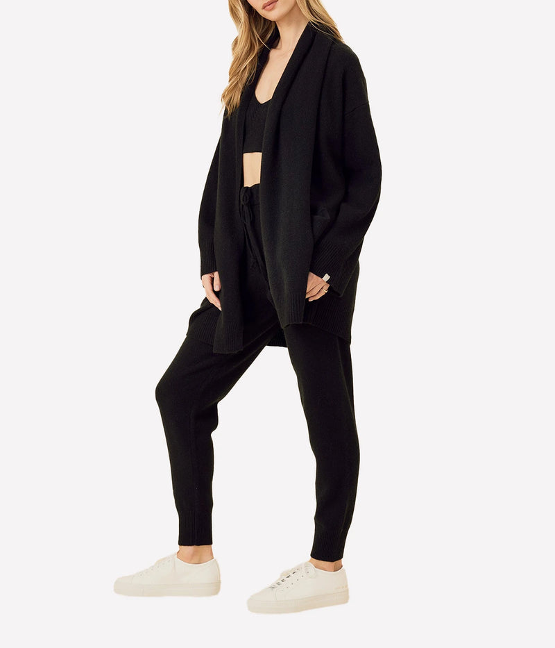 ALT Text: Colorado Cashmere Pant in Black, featuring a mid-gauge weight, adjustable drawstring waist, and functional pockets with branded whip-stitching for a luxurious yet practical design.