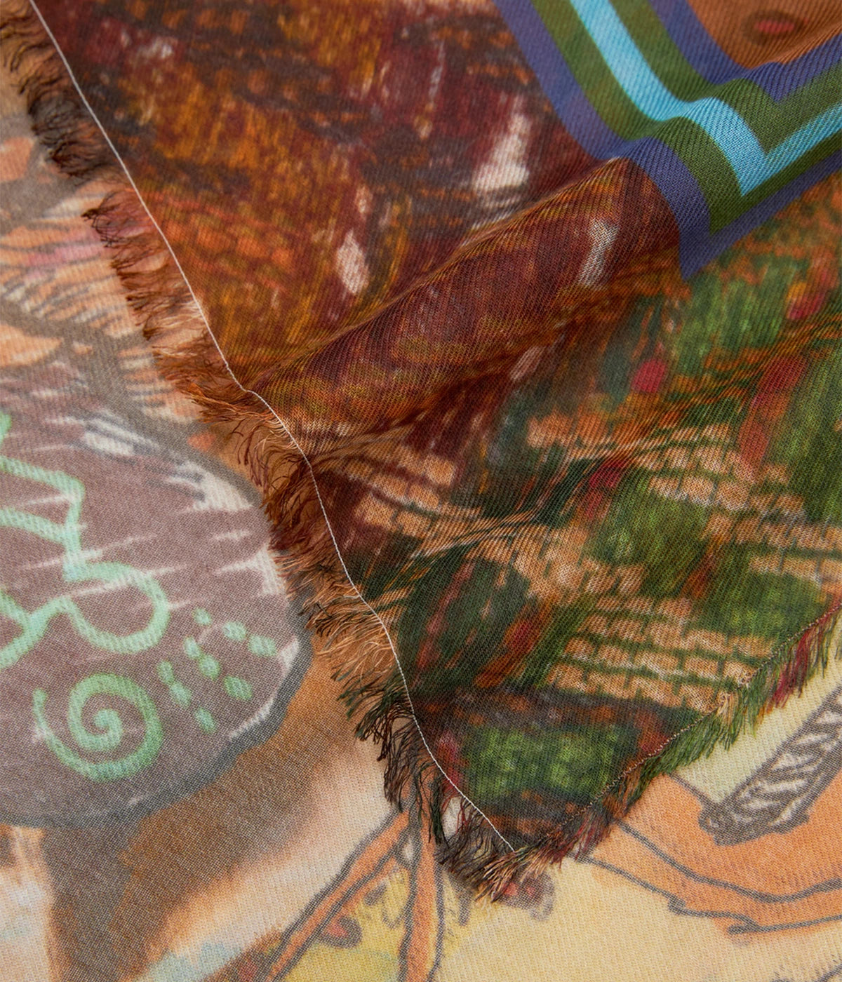 A luxurious modal and cashmere stole with earthy-toned illustrations, styled to complement a neutral outfit.